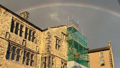 The Folly under repair, with scaffolding and a rainbow above the building