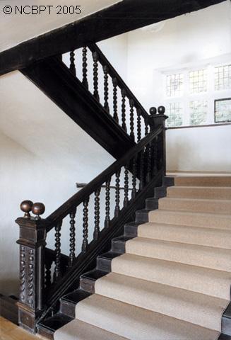 The oak staircase, with twisted balusters, moulded handrail and ball finials.