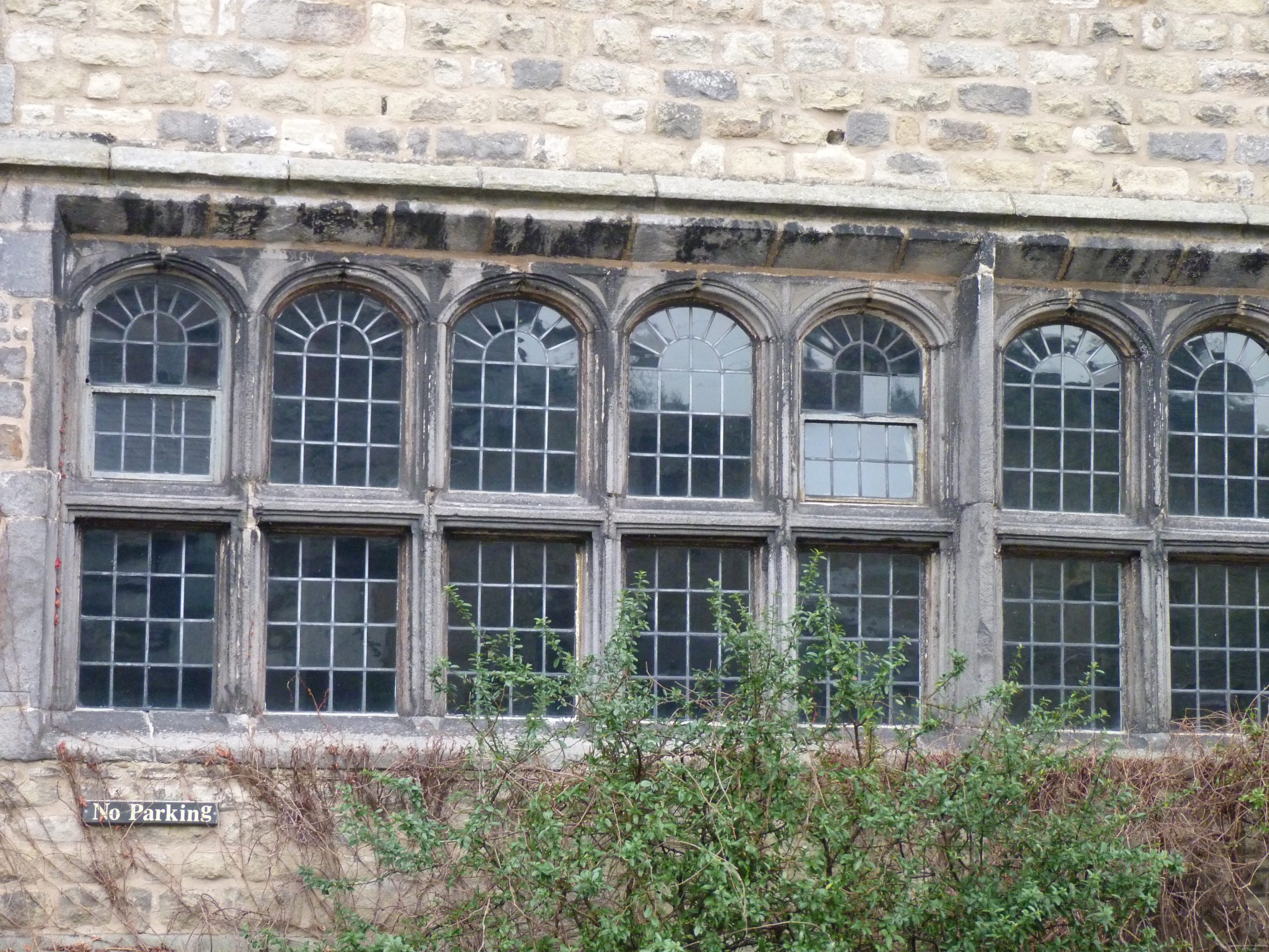 Stone-mullioned and transomed windows on the front elevation of The Folly