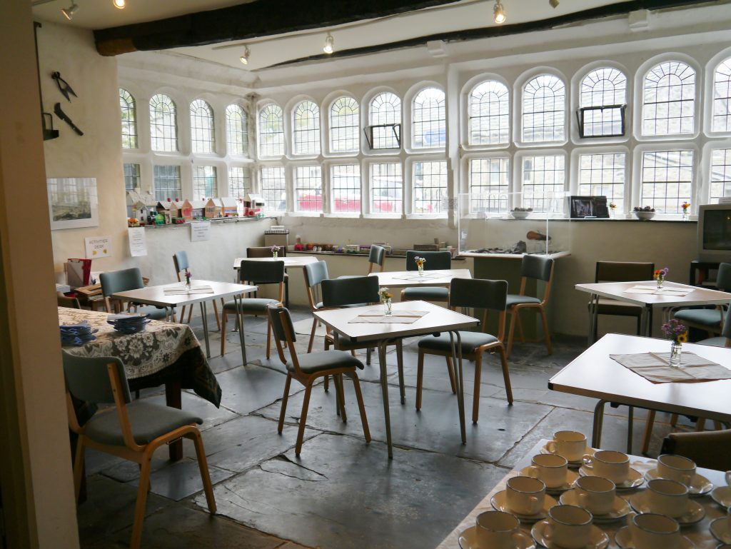 Interior of the Folly Parlour, with arched windows and tables